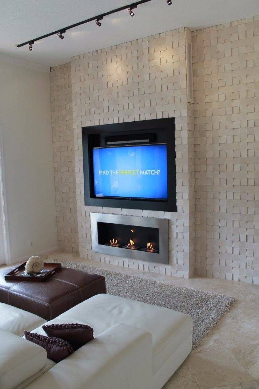 Modern accent wall with 3- d tile and modern stainless steel fireplace