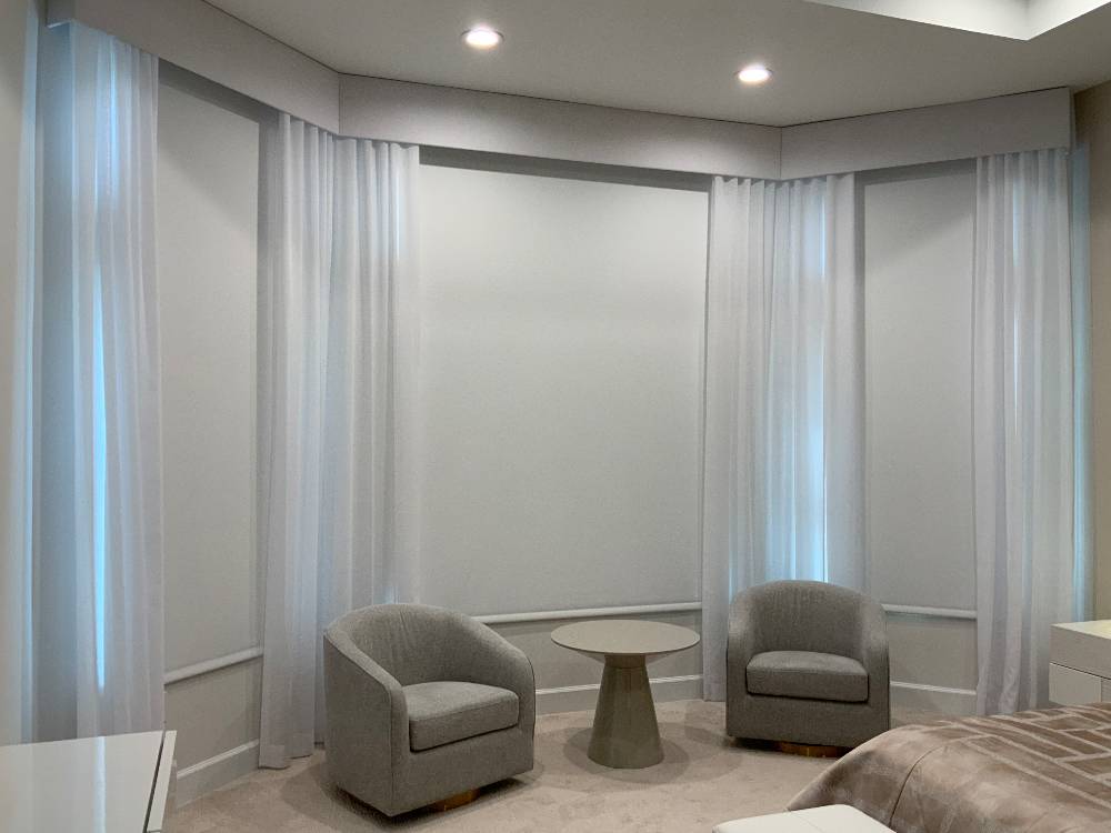 Modern roller shades with white linen curtains and elegant white linen cornice